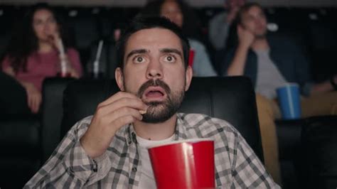 Slow Motion Of Scared Guy Eating Popcorn Watching Shocking Movie In