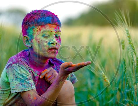 Image Of Indian Boy Or Young Indian Boy Playing Or Filled In Holi