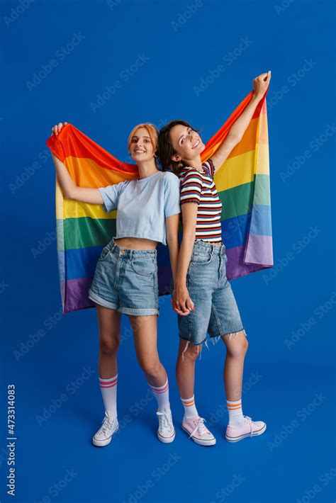 Excited Lesbian Couple Holding Hands While Posing With Rainbow Flag Foto De Stock Adobe Stock