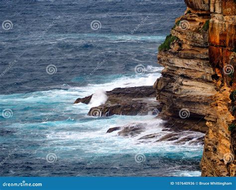 Pacific Ocean Waves Breaking On Rocks At Base Of Cliff Stock Photo