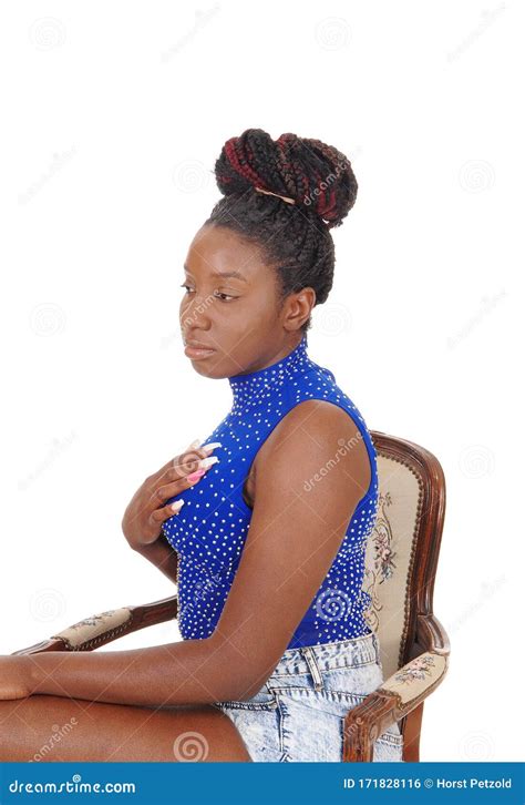 Serious Looking African Woman Sitting In A Chair Stock Photo Image Of