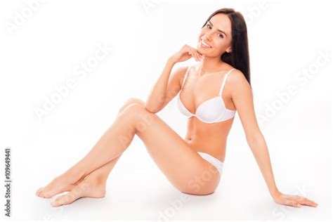 Portrait Of Sexy Brunette In White Underwear Sitting On White Ba