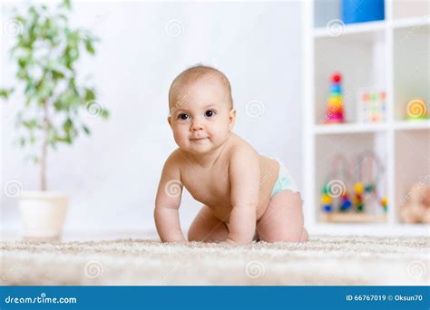 Happy Baby Child Smiling And Crawling On Floor In Nursery Stock Image