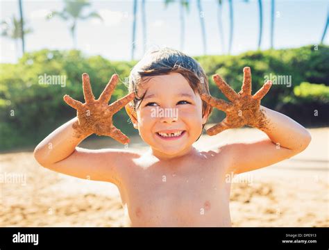 Happy Young Boy At The Beach Smiling With Sandy Hands Stock Photo Alamy