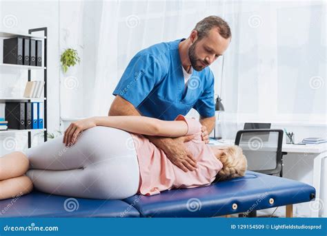 Chiropractor Massaging Back Of Patient That Lying On Massage Table Stock Image Image Of