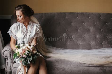 Gorgeous Beautiful Bride In Silk Robe And Veil Holding Modern Bo Stock