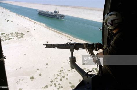 A Gunner In A Anti Submarine Helicopter Mans A M 60 Machine Gun As