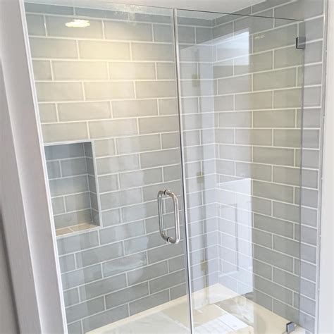 Bathroom remodeling offers a range of updates from fixtures and lighting to storage and shower door installation. Gray blue large subway tile from Home Depot, brand ...