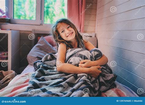 Happy Kid Girl Waking Up In Early Morning In Her Room Stock Image