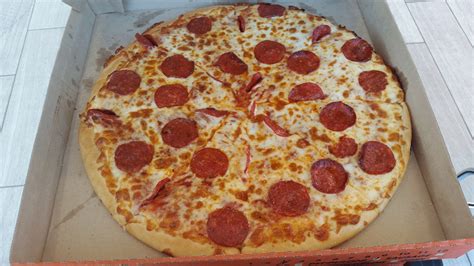 Domino's pizza is now making a pizza in new zealand and australia that literally envelops the. little caesars large pizza size