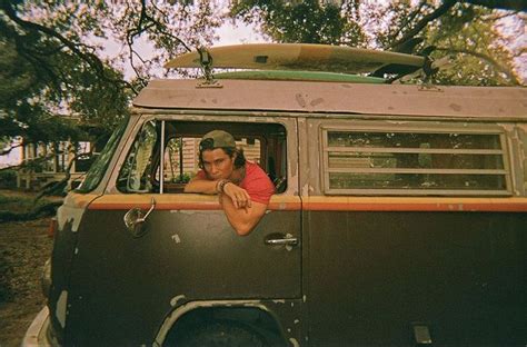 A Man Sitting In The Drivers Seat Of An Old Van