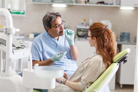 Dentist talking to patient about dental care - Wharton Dental Blog