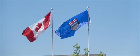 Canadian National And Alberta Provincial Flags At Full Mast Stock Photo