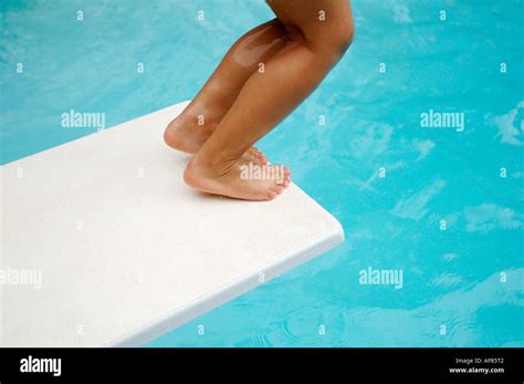Young Girl Jumping Off Diving Board Into Pool Stock Photo Royalty Free