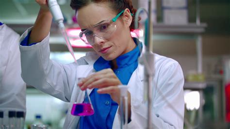 Female Chemist Doing Chemical Experiment Chemical Reaction In Glass