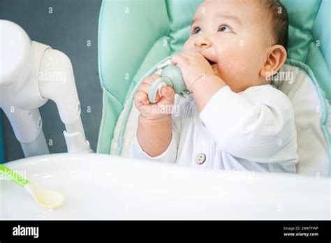 A Happy And Contented Baby Eats Banana Puree From A Nipple Introduction Of Complementary Foods