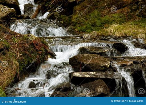 Closeup Of Mountain Creek Flowing Over Stones Waterfall Or Cascade On