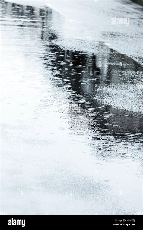 Wet Street Pavement With Raindrops And Puddles During Rain Stock Photo