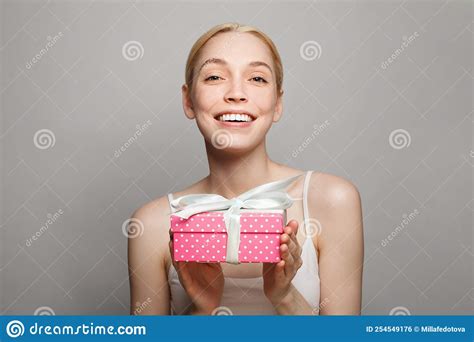 holidays celebration and women concept portrait of happy pretty blonde woman holding pink t