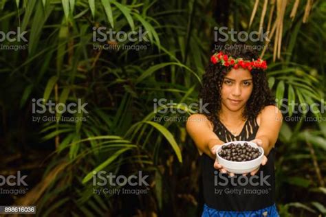 Pretty Brazilian Girl With Curly Hair Offering Acai Berry Fruit In A