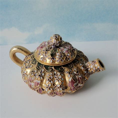An Ornately Decorated Teapot Sits On A Table