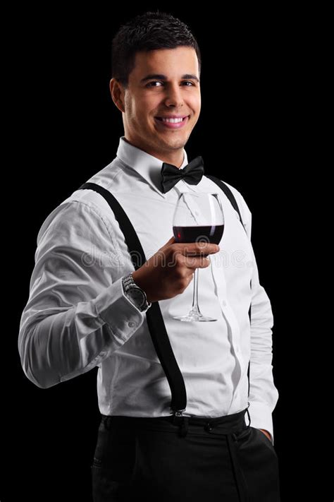 Man pouring wine to woman holding huge glass. Elegant Guy Holding A Glass Of Red Wine Stock Photo - Image of single, dark: 49250882