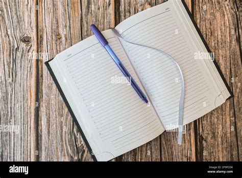 Opened Diary Or Notebook For Notes With Pen On Wooden Table Top View