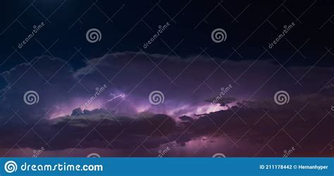 Lightnings In Heavy Purple Storm Clouds At Night Stock Photo Image
