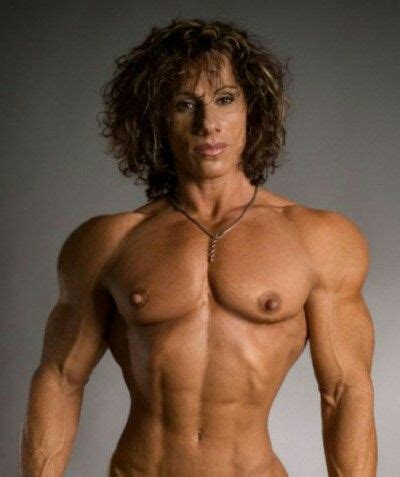 A Man With Long Hair And No Shirt On Posing For The Camera Showing Off