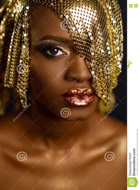 High Fashion Portrait Of Young African American Female Model With Gold