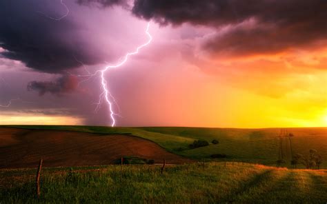 2560x1600 Thunderstorm Lightning Bolt Striking Down At Sunset In