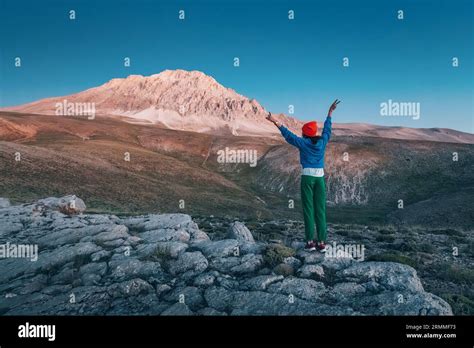 Embracing the Peaks: A nature enthusiast hikes through mountains