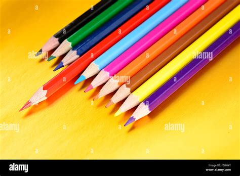 Color Pencils With Different Color Over Golden Background Stock Photo