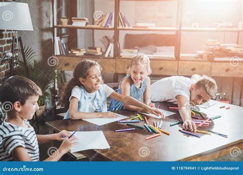 Multiethnic Group Of Happy Children Drawing Pictures Together Stock