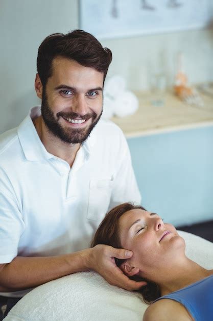 Premium Photo Smiling Physiotherapist Giving Head Massage To A Woman