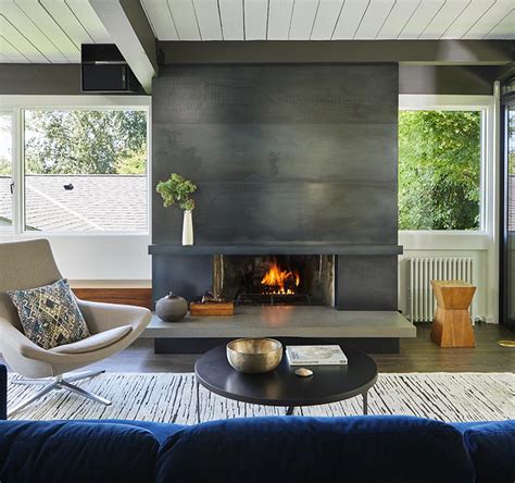 A Blackened Steel Fireplace Surround With A Concrete Hearth Is A Strong
