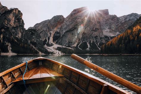 Brown Canoe In The Body Of Water Near Mountain · Free Stock Photo