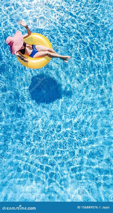 Beautiful Young Woman In Hat In Swimming Pool Aerial Top View From