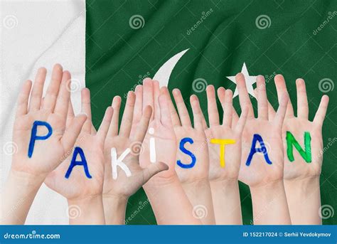 Inscription Pakistan On The Children`s Hands Against The Background Of