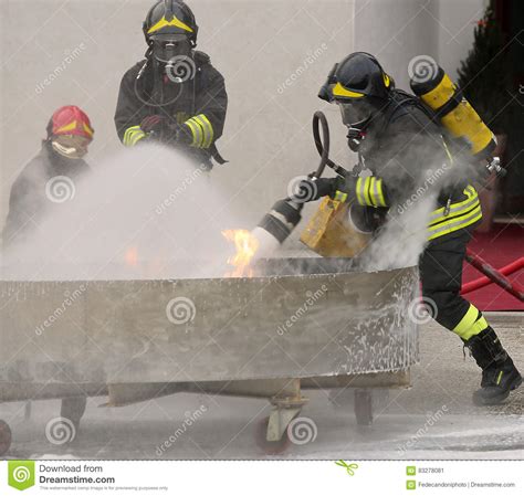 Group Of Firefighters During The Exercise To Extinguish A Fire W Stock