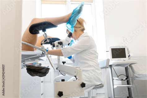 A Gynecologist Is Examined By A Patient Who Is Sitting In A Gynecological Chair Examination By
