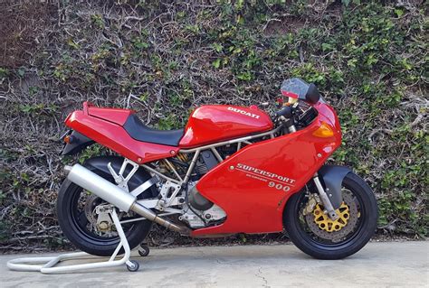 High spec version of the ducati 900ss with marvic wheels, tuned engine, higher exhausts carbon mudguard and #1 graphics. 1996 Ducati 900SS-SP SOLD — Moto Rosso Motorcycles