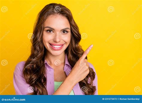 Portrait Of Attractive Cheerful Wavy Haired Girl Demonstrating Copy