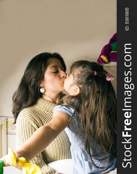 a mother and a daughter kissing free stock images and photos 5301805