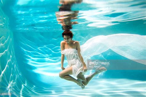 Portrait Of A Female Model In High Heels Underwater In A Swimming Pool