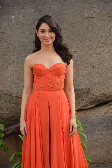 Desi Actress Pictures Tamanna Latest Stills In Red Shoulderless Dress At Thozha Movie Interview