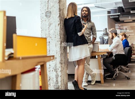 Colleagues In Office Talking Stock Photo Alamy