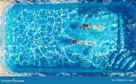 Active Girls In Swimming Pool Water Aerial Drone View From Above