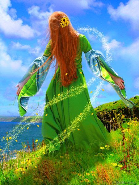 A Woman In A Green Dress Standing On Top Of A Grass Covered Hill Next