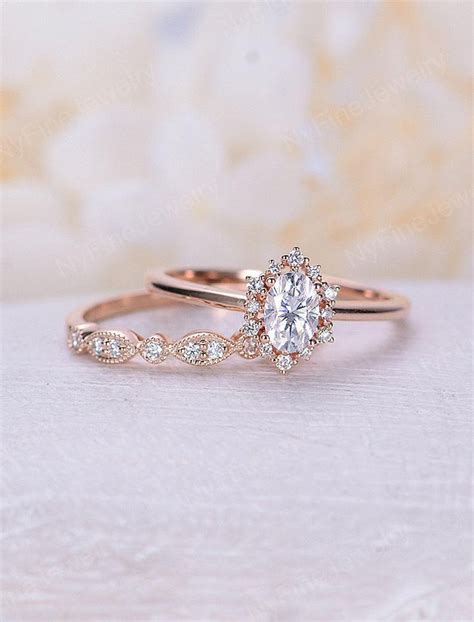 A Rose Gold Engagement Ring Set With An Oval Diamond